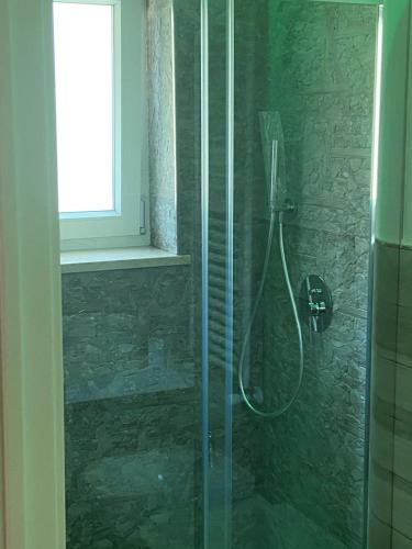 a shower with a glass door in a bathroom at House Villa Anna in Polignano a Mare
