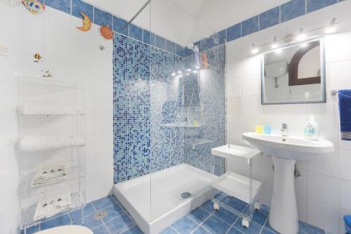 a bathroom with a sink and a toilet and a shower at Casa Sottorar - Loft Open Space in Corricella in Procida