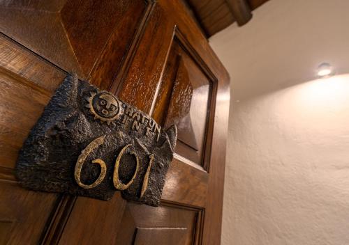 a wooden door with the word god written on it at Hatun Inti Boutique in Machu Picchu