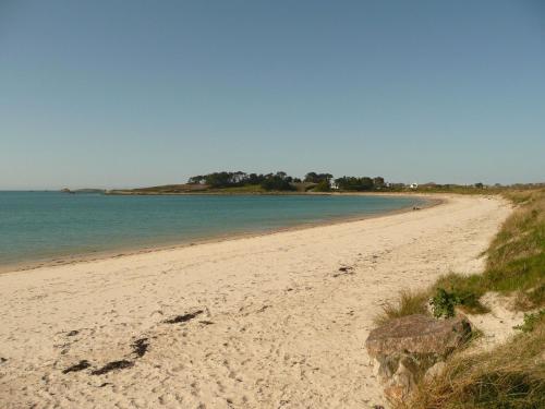 a sandy beach with the ocean in the background at Stone House in Brittany near the Sea in Lannilis