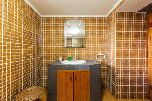 a bathroom with a sink and a mirror at holiday home, Santo Amaro, Pico, Azores in Santo Amaro