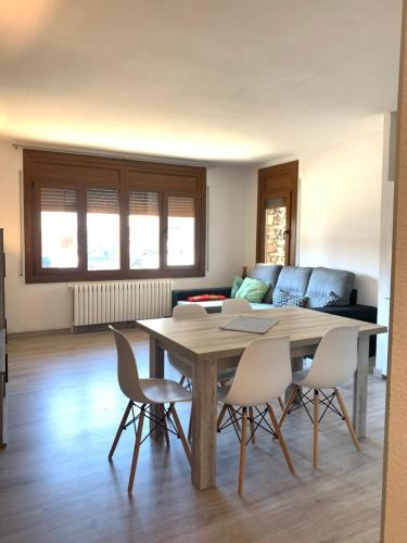 a living room with a table and chairs and a couch at PASSAMANÉ 19 - Canillo - Casco Antiguo Hut 7867 in Canillo