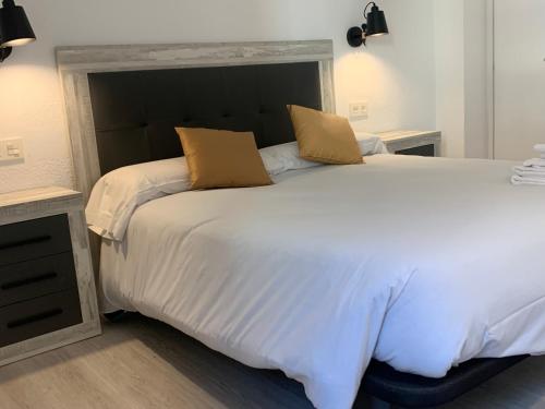 a large white bed with two pillows on it at PASSAMANÉ 19 - Canillo - Casco Antiguo Hut 7867 in Canillo