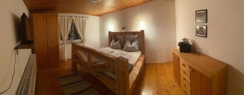 ein Schlafzimmer mit einem Holzbett in einem Zimmer in der Unterkunft Alpen Apartement in Hallstatt
