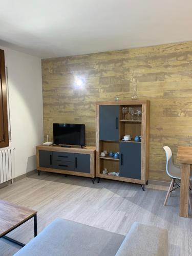 a living room with a tv and a wooden wall at PASSAMANÉ 19 - Canillo - Casco Antiguo Hut 7867 in Canillo
