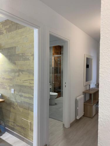 a room with a bathroom with a stone wall at PASSAMANÉ 19 - Canillo - Casco Antiguo Hut 7867 in Canillo