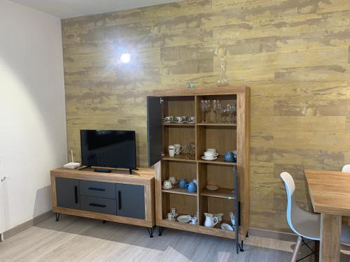 a living room with a tv and a wooden wall at PASSAMANÉ 19 - Canillo - Casco Antiguo Hut 7867 in Canillo