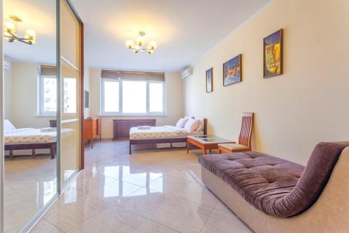 a large living room with a couch and a living room at Роскошная 3к квартира 125м2 на набережной in Kyiv