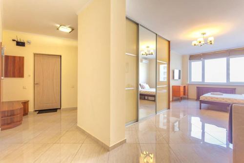 a living room with a room with a bed and a door at Роскошная 3к квартира 125м2 на набережной in Kyiv