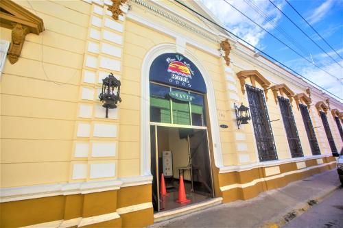 a yellow building with orange cones in front of it at Hotel Plaza Mirador in M&eacute;rida
