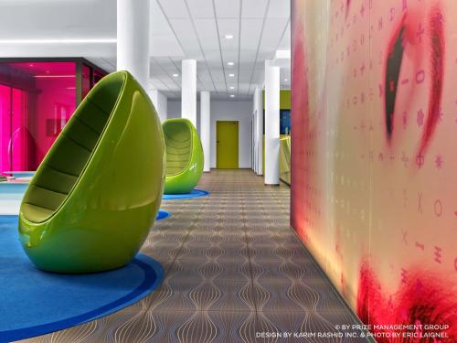 a hallway with two green slides in a building at Prize by Radisson, Hamburg City in Hamburg