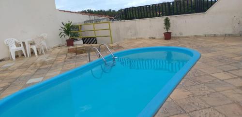 a blue swimming pool on a patio at Hotel Canto Da Praia in São Luís