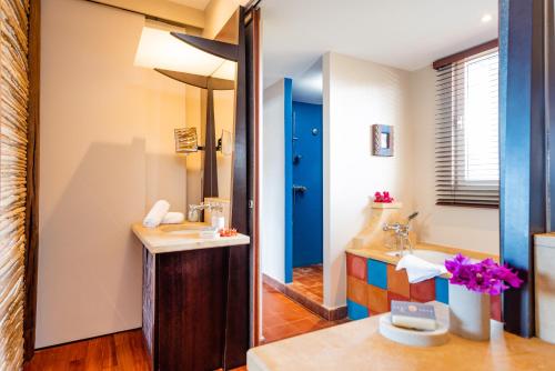 a bathroom with a sink and a mirror at EAST KEYS - East Lagoon Suites in Le François