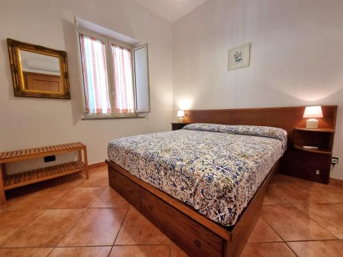a bedroom with a bed and a mirror on the wall at Il Limoneto in Furore