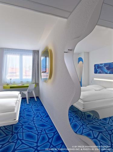 a rendering of a hotel room with a bedroom at Prize by Radisson, Hamburg City in Hamburg