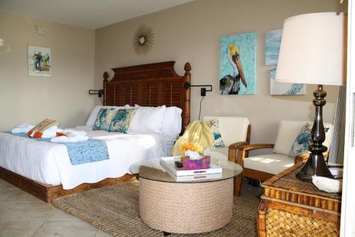 a bedroom with a bed and a table and a chair at Bay Mariner - Gorgeous Water Front Condo! in Sarasota