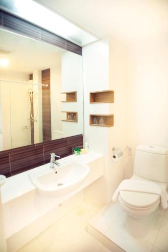 a white bathroom with a toilet and a sink at P2 Boutique in Bangkok