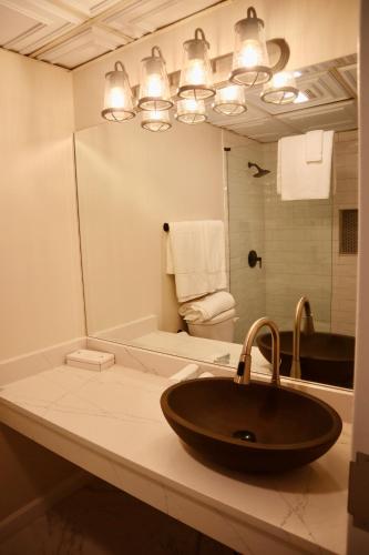 a bathroom with a sink and a mirror at The Shore Club in Spring Lake Heights