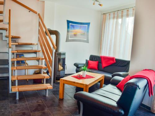 a living room with a couch and a table at Ferienhaus Bodden in Neuendorf