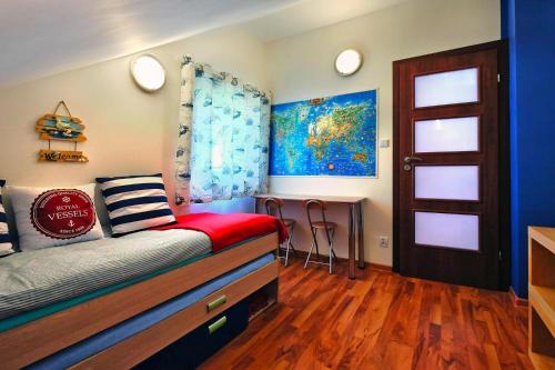 a bedroom with a bed and a table in it at Holiday Home in Lukecin near Baltic Beach in Łukęcin