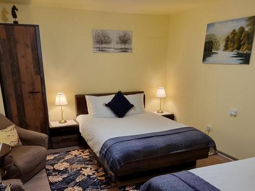 a bedroom with a bed and a couch and two lamps at Roca House in Braşov