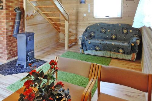 a living room with a stove and a couch and a table at Holiday resort, Wiselka in Wisełka