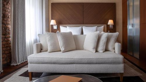 a bed with white pillows in a hotel room at La Réserve Eden au Lac Zurich in Zürich