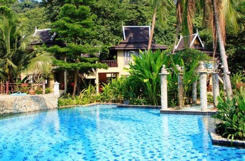 a swimming pool in front of a house at Bhumiyama Plus in Ko Chang