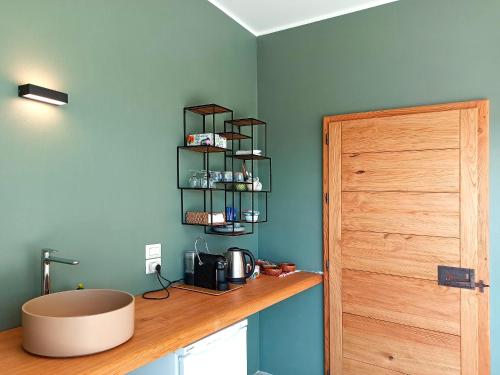 a kitchen with a wooden counter and a wooden door at Agriturismo Casa Greppo in San Venanzo