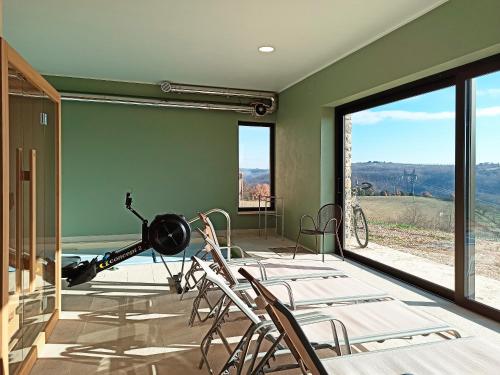 a room with chairs and a large glass window at Agriturismo Casa Greppo in San Venanzo