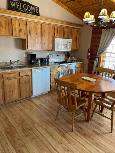 a kitchen with a wooden table and a wooden floor at Crown Lake Resort in Horseshoe Bend