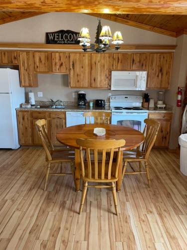 a kitchen with a wooden table and chairs in a kitchen at Crown Lake Resort in Horseshoe Bend