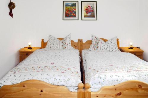 two twin beds in a bedroom with two candles on tables at House, Steinbach-Hallenberg in Altersbach