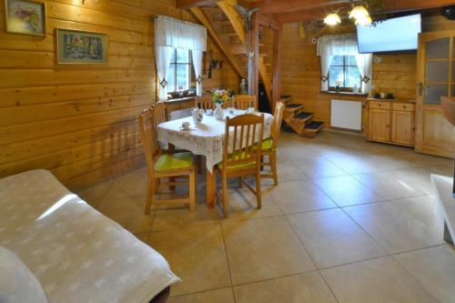 a dining room with a table and chairs at Holiday home by the lake, private garden, Oswino in Oswino