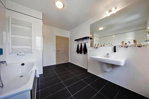 Un baño blanco con dos lavabos y un espejo. en Doppelhaushälften, Strausberg, en Strausberg