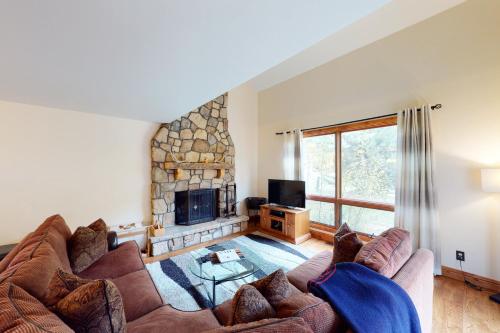 a living room with a couch and a fireplace at Avon Golf Getaway in Avon