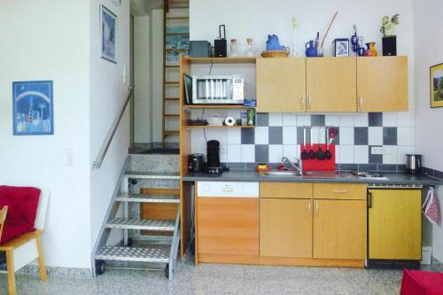 a kitchen with a counter and a staircase in a room at Apartment, Zell im Wiesental in Zell im Wiesental