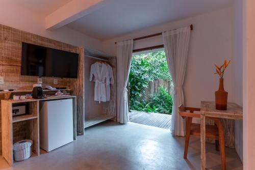 a living room with a sliding glass door at DA GRAÇA HOTEL in Trancoso
