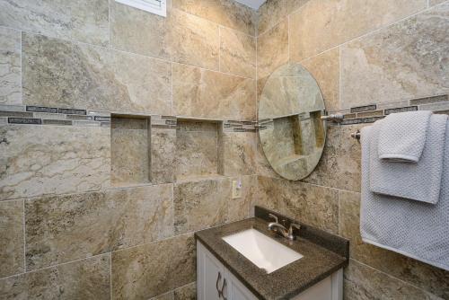 a bathroom with a sink and a mirror at Canal 315 - Right in Siesta Key Village! in Siesta Key