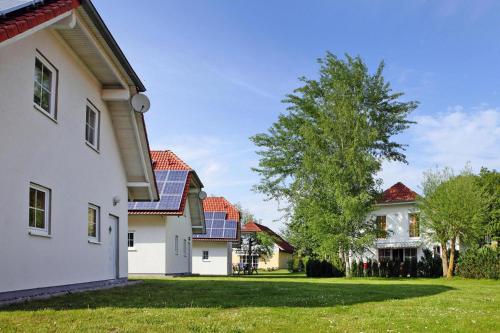 una fila de casas con paneles solares en sus tejados en Cottages at the Kummerower See Verchen, en Verchen