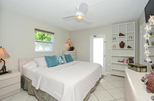 a bedroom with a bed and a ceiling fan at Canal 313 - Right in Siesta Key Village! in Siesta Key