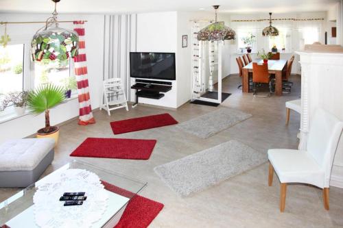 a living room with a television and a dining room at Ferienhaus Adler in Mirow in Mirow