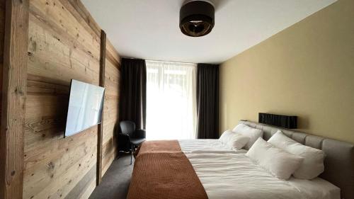 a bedroom with a large bed and a window at Golden Peak in Sankt Anton am Arlberg
