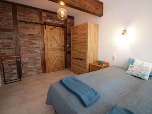 a bedroom with a bed and a wooden door at Holiday home Residence in Zastan in Zastań