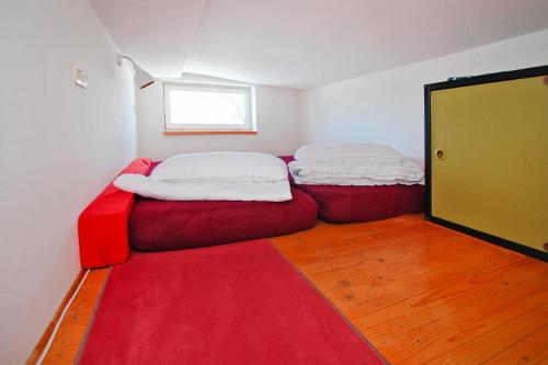 two beds in a room with a red carpet at Semi-detached house at Flacher See, Klocksin in Klocksin