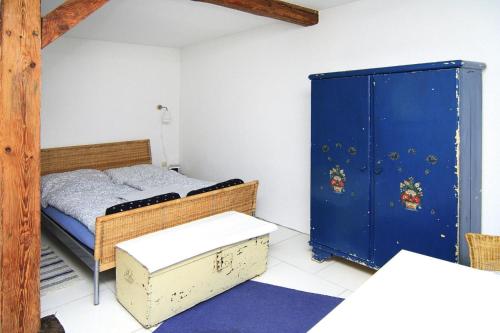 a bedroom with a bed and a blue locker at Apartment, Plau am See in Plau am See
