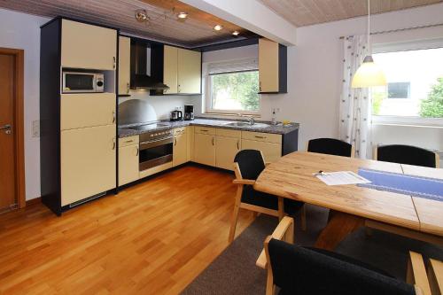 cocina con mesa de madera y comedor en Holiday resort in the M ritz National Park Mirow, en Mirow