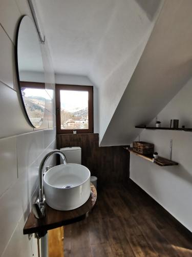 a bathroom with a sink and a window at CASUTA CU SINDRILA in Dragoslavele