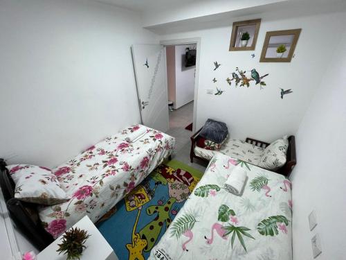 a small bedroom with two beds and a bedspread at צימר גבול החרמון in Majdal Shams