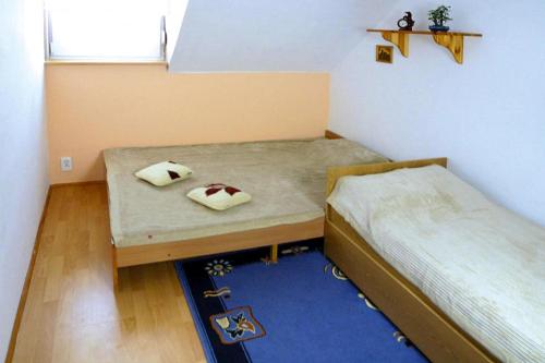 a small room with two beds and a blue rug at Terraced house, Rewal in Rewal
